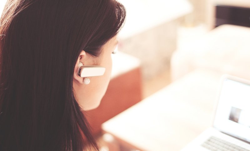 Customer service worker with a headphone and a laptop